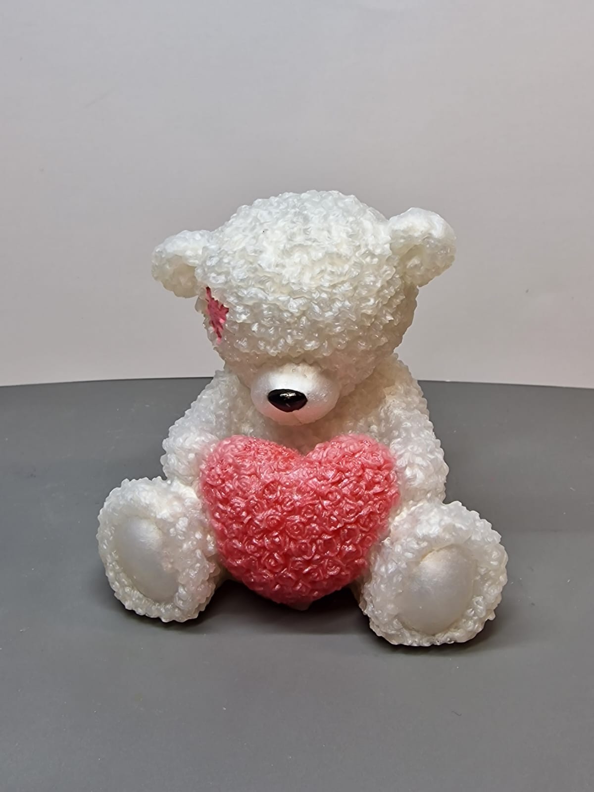 White teddy bear with pink heart