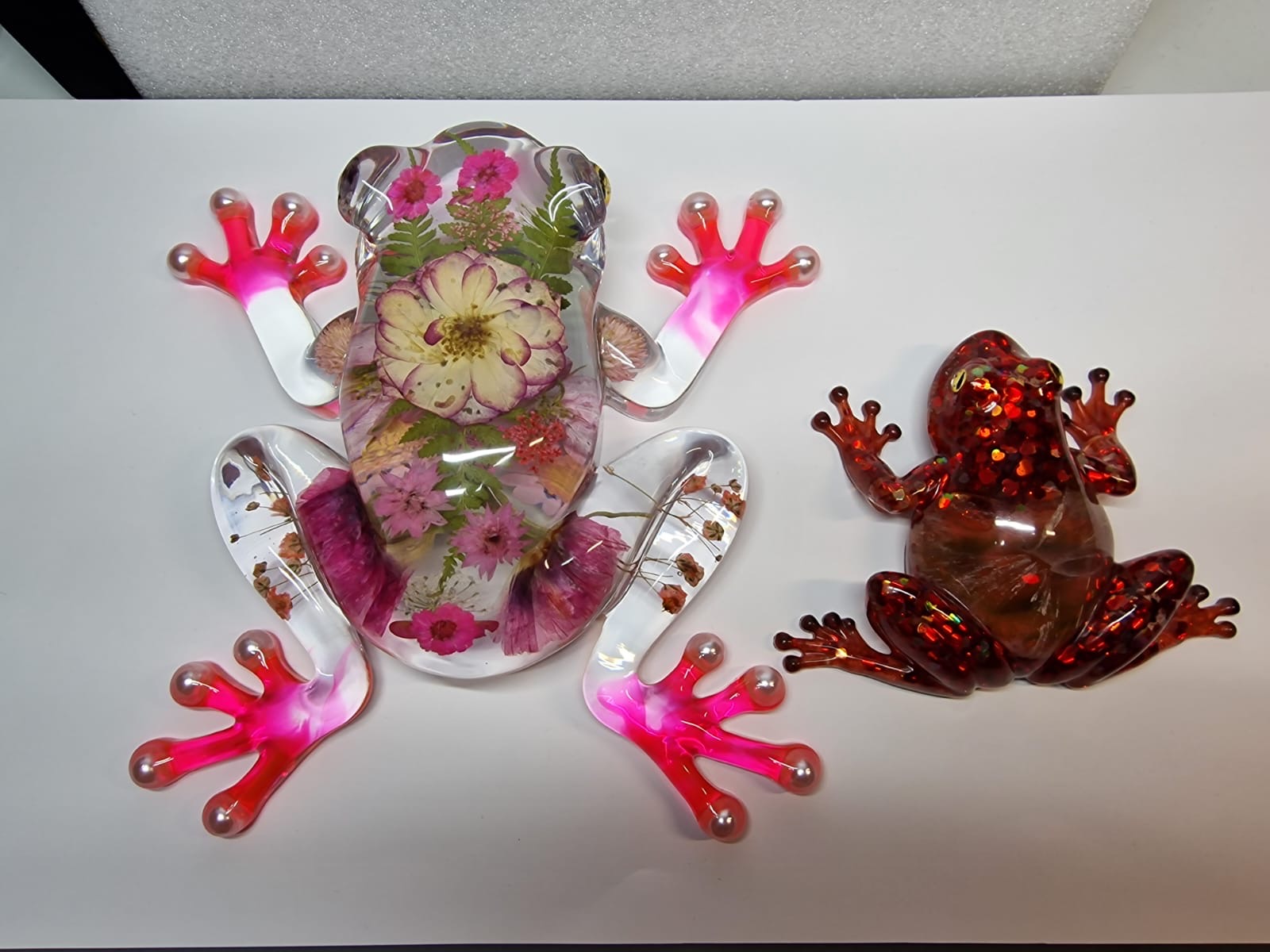 Two resin frogs together